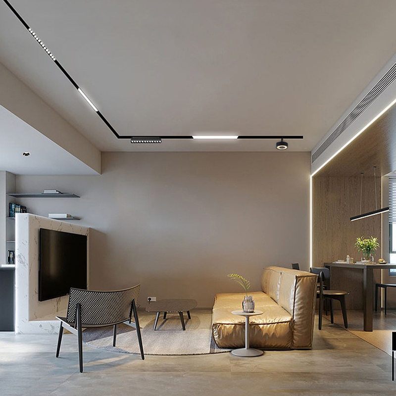 Black magnetic track with spot, grille and linear heads running across a living-room ceiling